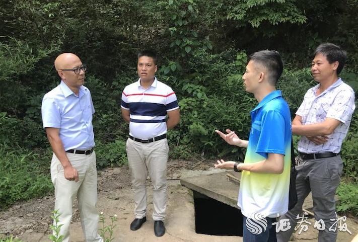 李經緯（右二）與中國太保產險清遠中支負責人、村干部一道探討村里飲水難問題的解決方案.jpg